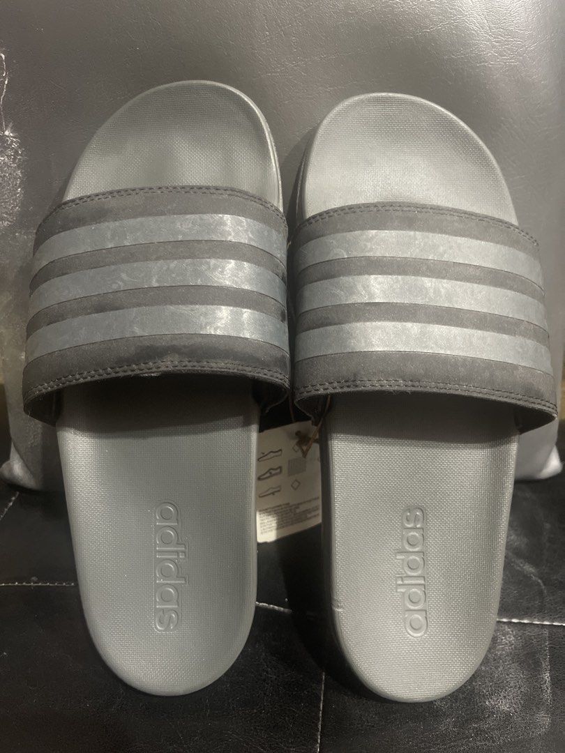 Adidas Adilette Comfort Slides - Grey (Category: Slippers & Slides) located in Manila. Submitted by rizver2026 (Listing ID 1439097992, Image 1). Description: Adidas Adilette Comfort slides in grey. Features the classic three stripes design. The slides have a textured footbed and sole for grip and comfort. Includes the original tag with the price of PHP 1,800. Size is indicated as 6 (US) and 39 (EU)..