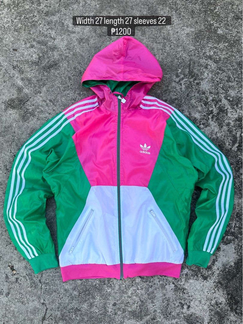 Adidas Colorblock Hooded Jacket (Category: Coats, Jackets and Outerwear) located in Daet. Submitted by thrifthings2018 (Listing ID 1439190042, Image 1). Description: - Adidas colorblock jacket - Green, pink, and white color scheme - Adidas logo on chest - Three stripes on sleeves - Zipper closure - Two front pockets - Made in Indonesia - Size L - Measurements: Width 27", Length 27", Sleeves 22".