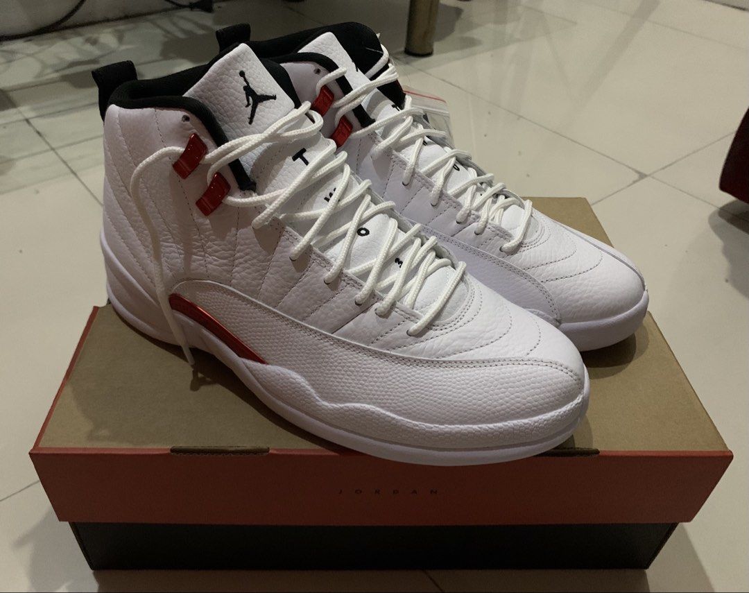 Air Jordan 12 Retro White/Red (Category: Sneakers) located in Quezon City. Submitted by jdlshop (Listing ID 1439211093, Image 1). Description: - Air Jordan 12 Retro - Color: White and Red - Condition: Unworn - Includes original box - Features Jumpman logo on box - White laces and red accents - Never been worn/ used.