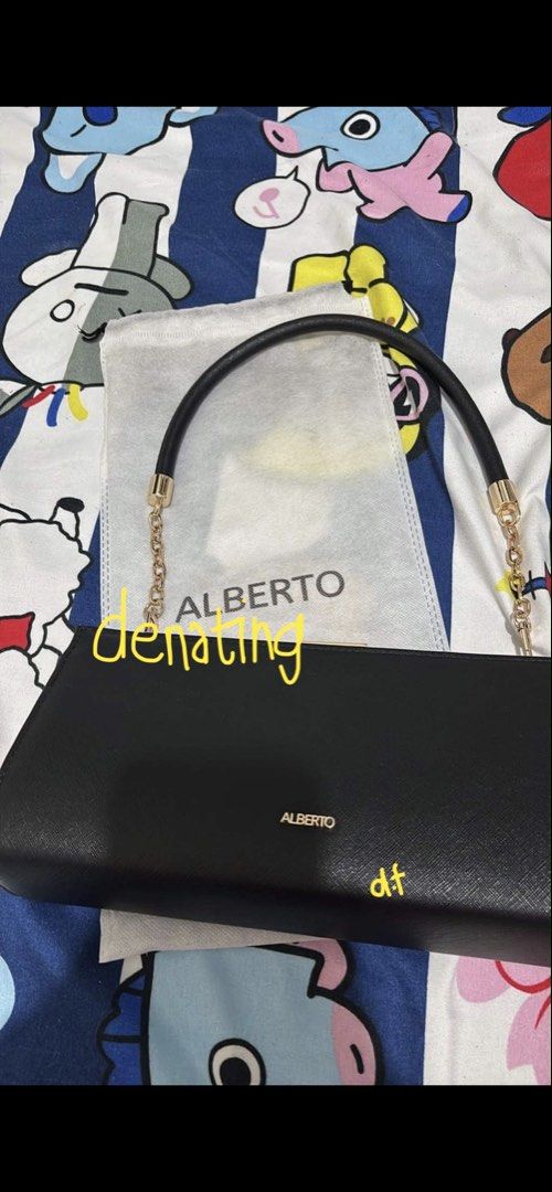 Alberto Black Handbag with Chain Strap (Category: Shoulder Bags) located in Caloocan City. Submitted by denating (Listing ID 1439188275, Image 1). Description: - Brand: Alberto - Color: Black - Features: Chain strap, clasp closure - Shape: Rectangular - Design: Sleek - Interior: Patterned fabric lining - Includes: Dust bag - Details: Brand name visible on front - Used one time only. Got rid the bag. - Got from physical store ❗️❗️ Had an emergency