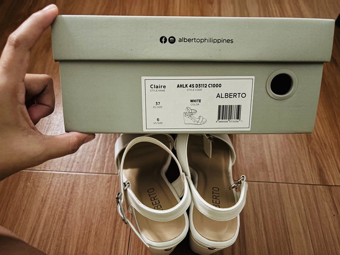 Alberto Claire White Wedge Sandals (Category: Sandals) located in Cavite. Submitted by MalynHey (Listing ID 1439114860, Image 2). Description: - Alberto Claire wedge sandals - Size: 37 EU / 6 US - Color: White - Features: Buckle closure, silver studs - Condition: Unworn - Includes original box.