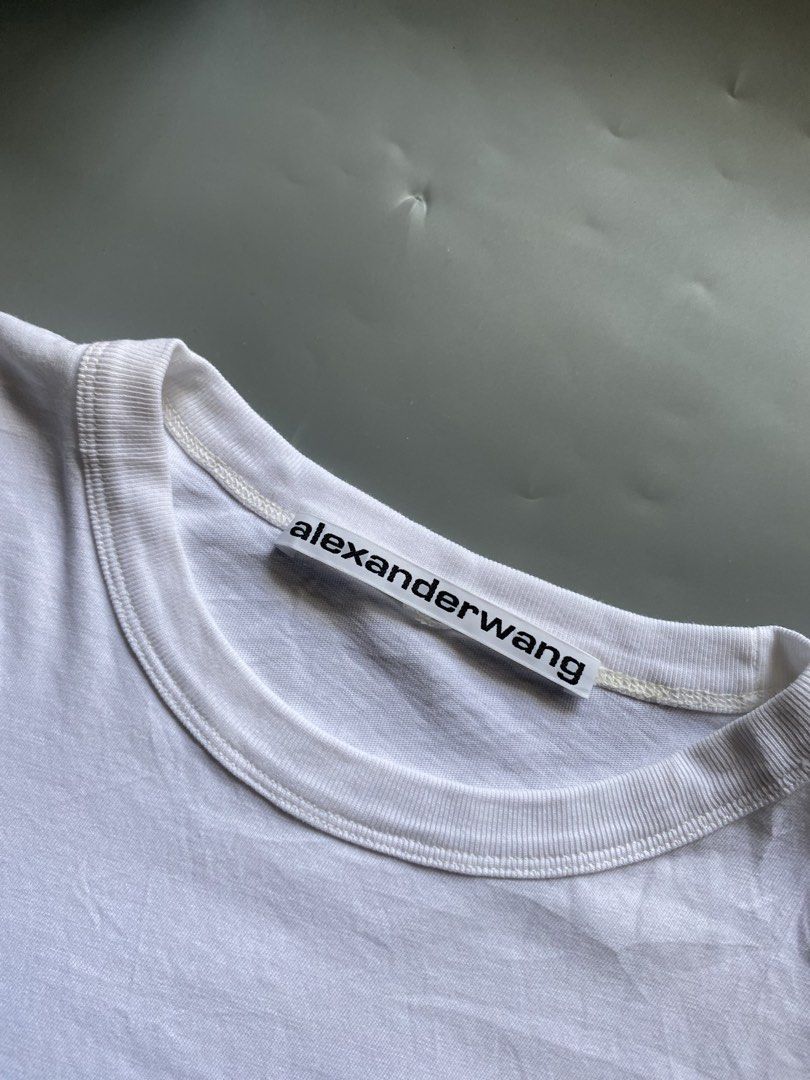 Alexander Wang Cropped White T-shirt (Category: Shirts) located in Manila. Submitted by thriftwhoop (Listing ID 1439158551, Image 3). Description: - Alexander Wang cropped t-shirt - Color: White - Features: Chest pocket, Alexander Wang logo - Made in Vietnam - Material: 100% Cotton - Neckline: Crew neck - Sleeves: Short sleeves.