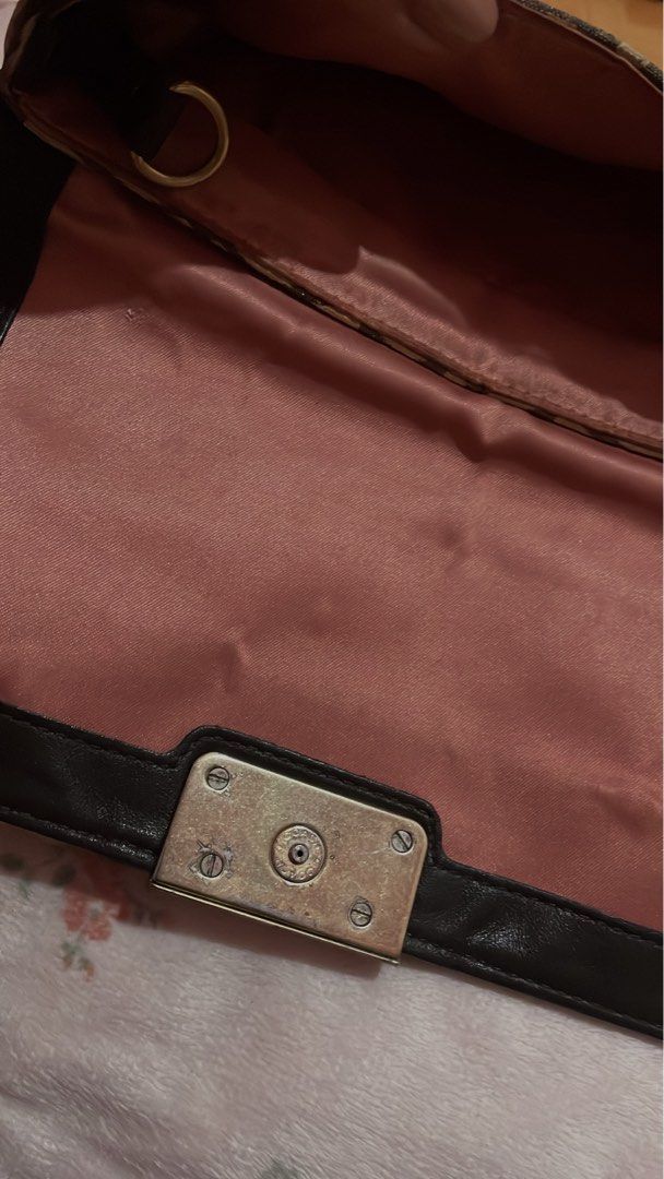 Authentic Coach Signature Turnlock Wristlet (Category: Purses & Pouches) located in Caloocan City. Submitted by ruby_welly22 (Listing ID 1439210279, Image 3). Description: Pre-loved. Canvas and interior are clean, leather strap is intact. Hardware has visible scratches/fading on the turnlock plate due to use (see photos), but it still locks perfectly. .