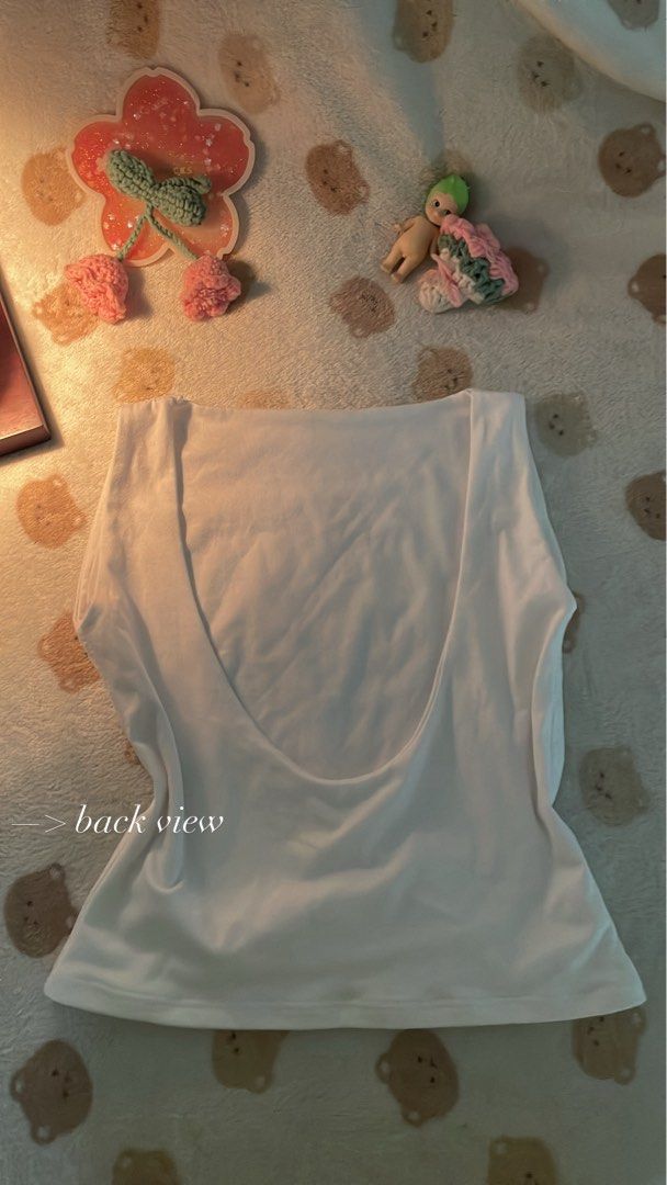 Backless White Top (Category: Sleeveless) located in Makati City. Submitted by kzisdeclutter (Listing ID 1439245839, Image 2). Description: - White backless top - Scoop back design - Made of soft, stretchy material - Versatile style - Perfect for layering - Price: 150 pesos.