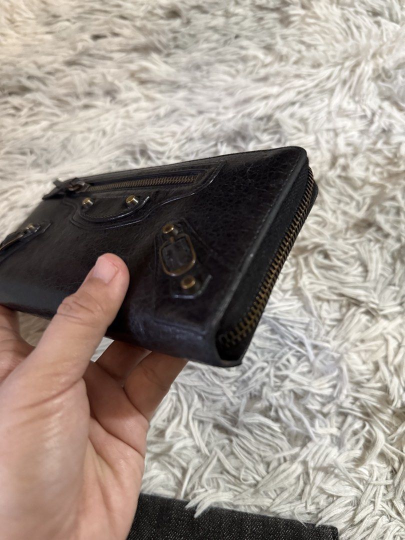 Balenciaga Black Leather Wallet (Category: Luxury Bags & Wallets) located in Binan City. Submitted by jgca01 (Listing ID 1439086650, Image 3). Description: - Guranteed orig Black leather wallet - Zip closure - Multiple compartments and card slots - Includes wrist strap - Textured leather exterior - Brass-colored hardware - money back if proven fake by authorized authenticator.