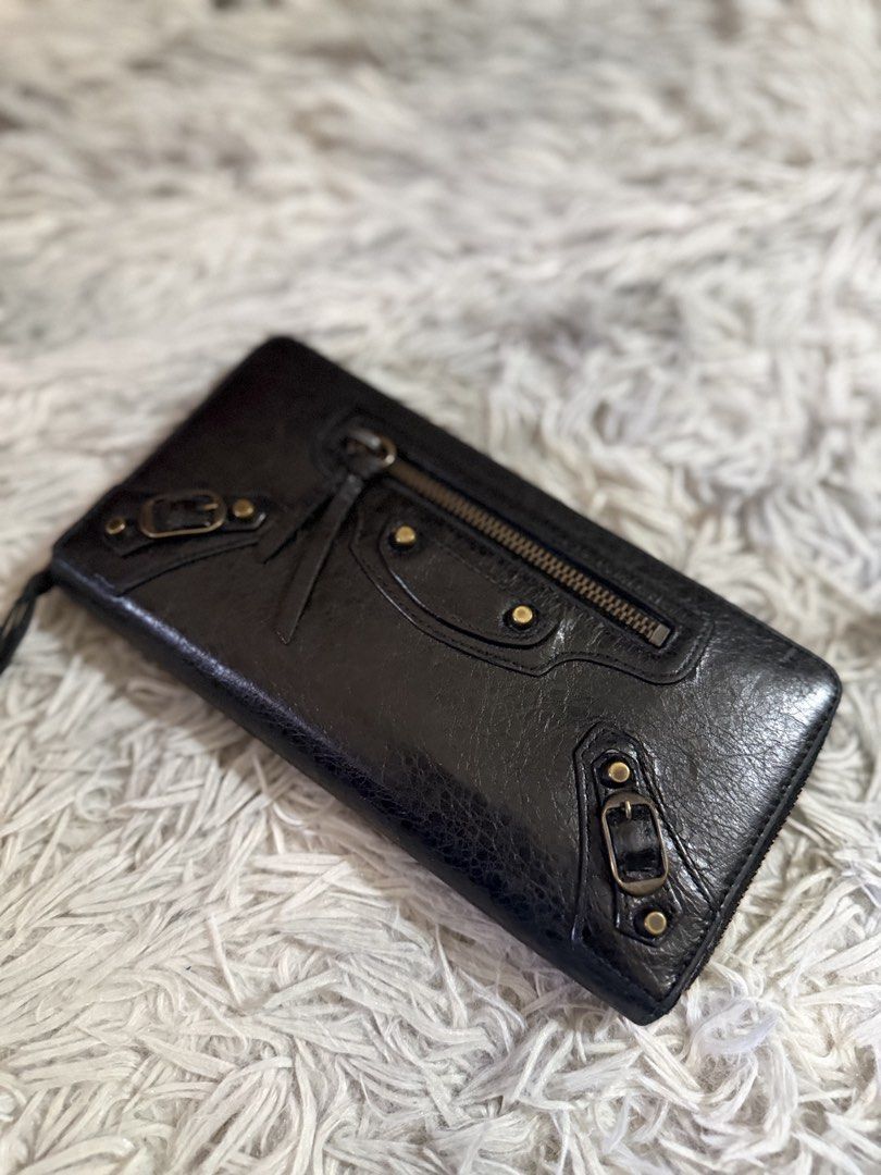 Balenciaga Black Leather Wallet (Category: Luxury Bags & Wallets) located in Binan City. Submitted by jgca01 (Listing ID 1439086650, Image 1). Description: - Guranteed orig Black leather wallet - Zip closure - Multiple compartments and card slots - Includes wrist strap - Textured leather exterior - Brass-colored hardware - money back if proven fake by authorized authenticator.