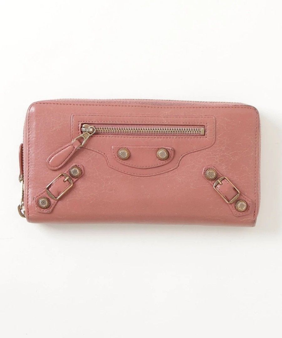 Balenciaga Classic Zip Around Wallet (Category: Luxury Bags & Wallets) located in Bacacay. Submitted by jpbellen80790 (Listing ID 1439229746, Image 1). Description: - Authentic Balenciaga Classic Zip Around Wallet - Color: Pink - Features: - Zip-around closure - Exterior zip pocket - Decorative buckles - Hardware: Brass color - Material: Textured leather - Design: Classic rectangular shape.