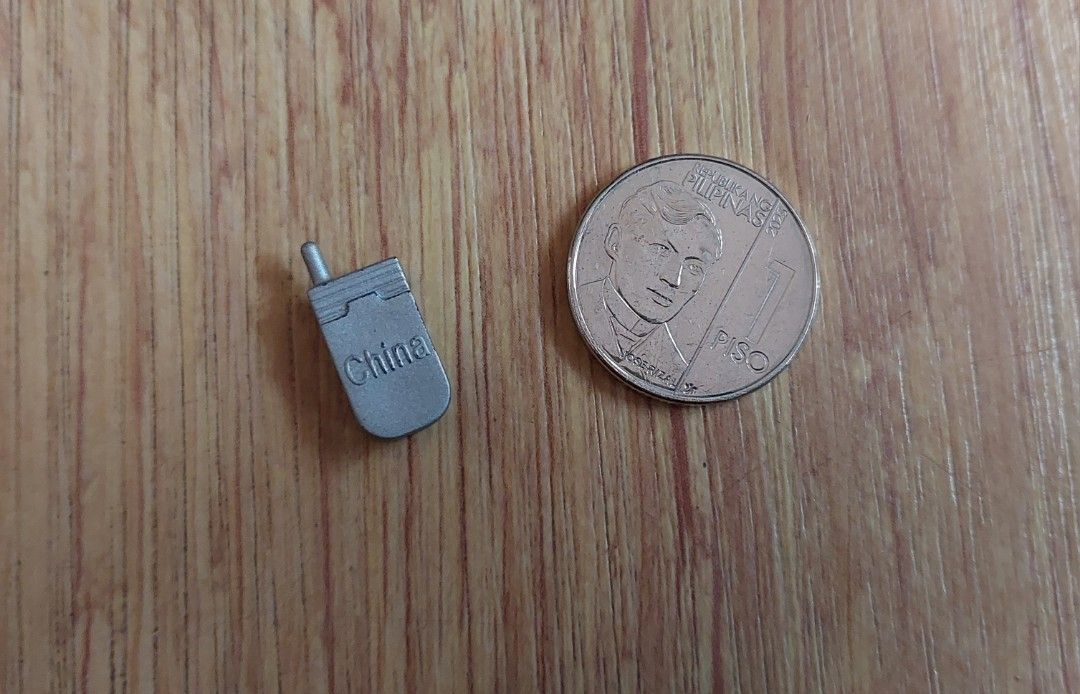 Barbie Flip Phone Vintage (Category: Early Generation Mobile Phones) located in Manila. Submitted by tsinelasni55674 (Listing ID 1439160253, Image 3). Description: Barbie silver flip phone Mattel Collectible Small size, shown with 1 Piso coin for scale For further inquiries feel free to welcome us your message about the item.🙆 Kindly imit your expectation since the item is preloved. except from new oldstock. Shipping Fee: care of buyers via Grab