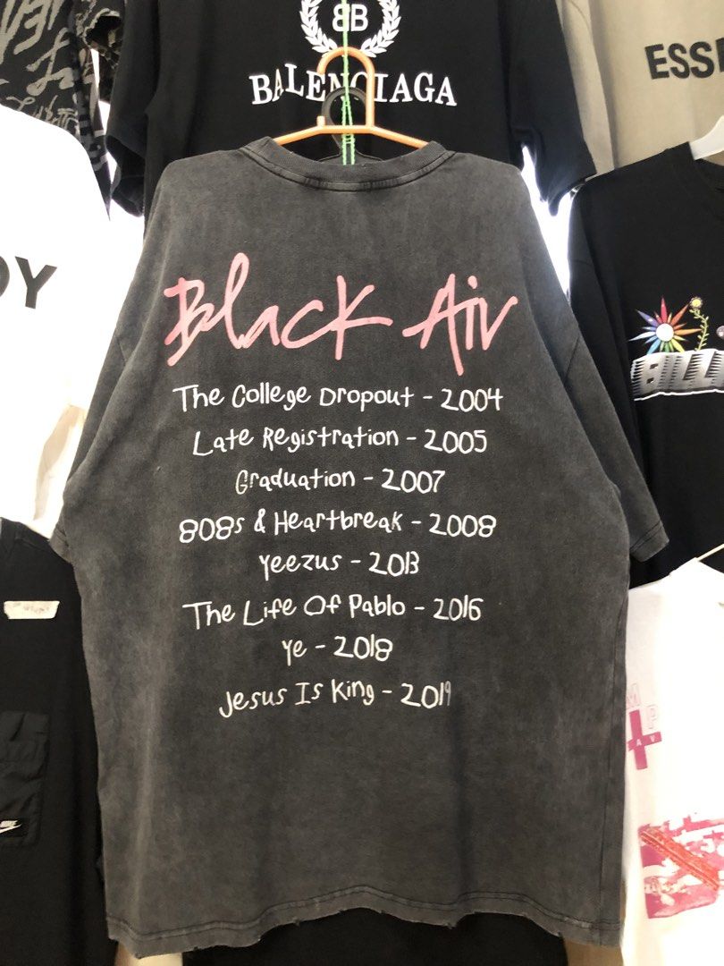 Black Air Global Spread Graphic Tee (Category: Tshirts & Polo Shirts ) located in Bulacan. Submitted by thrifted.master (Listing ID 1439148268, Image 2). Description: - Oversized black t-shirt - Features a "Black Air" graphic on the front - "Global Spread" text below the graphic - Back print includes album titles and years: - The College Dropout - 2004 - Late Registration - 2005 - Graduation - 2007 - 808s & Heartbreak - 2008 - Yeezus - 2013 - The