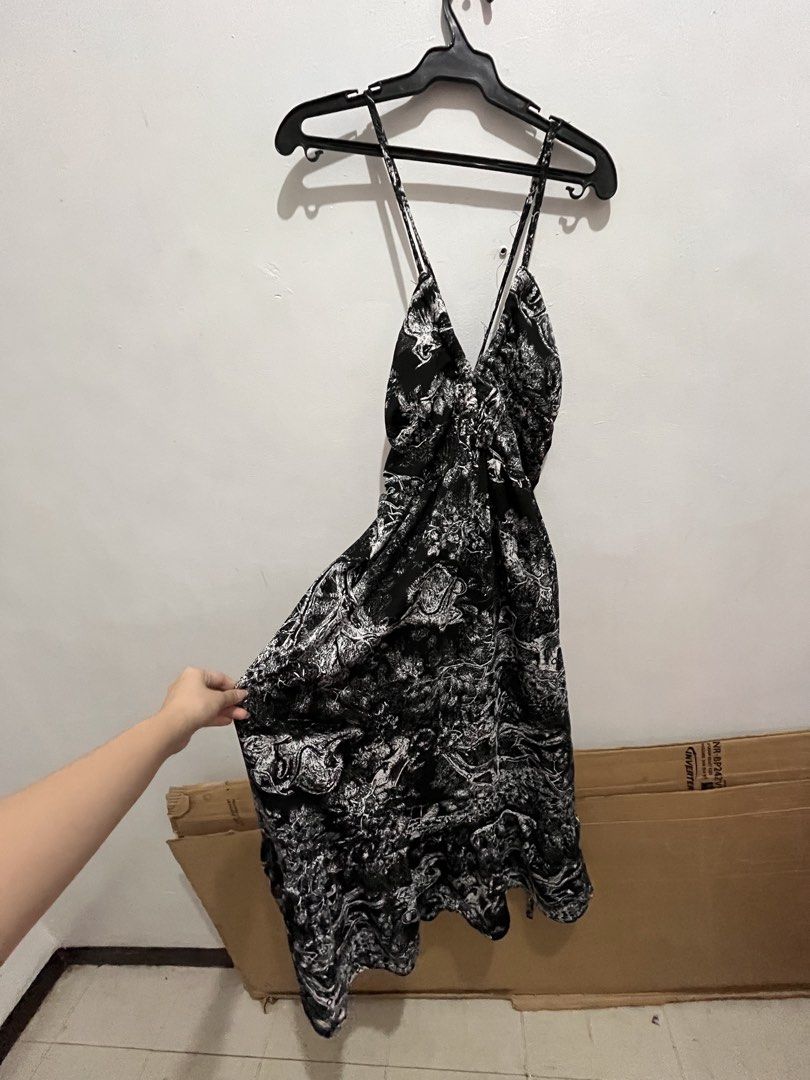 Black and White Printed Dress (Category: Dresses) located in Manila. Submitted by rhibosomes_ (Listing ID 1439236928, Image 1). Description: - Black and white print - V-neckline - Spaghetti straps - Cinched waist - Flowing skirt - Unique tie details - Knee-length - Perfect for casual or semi-formal events - backless No last price, DM for videos when worn.