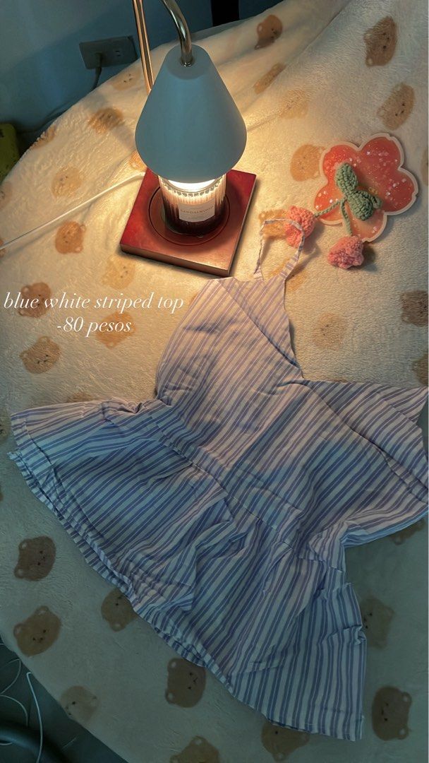 Blue and White Striped Top (Category: Blouses) located in Makati City. Submitted by kzisdeclutter (Listing ID 1439245862, Image 1). Description: - Blue and white striped pattern - V-neck design - Thin straps - Gathered waistline - Lightweight and comfortable - Perfect for warm weather - 80 pesos.