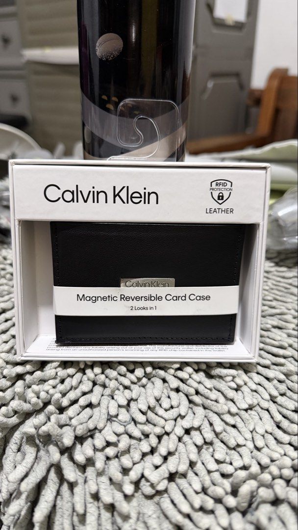Calvin Klein Magnetic Reversible Card Case (Category: Wallets & Card holders) located in Marikina City. Submitted by Bosmic (Listing ID 1439212908, Image 2). Description: - Authentic / Bought in USA - Calvin Klein card case - Magnetic reversible design - Two looks in one - Made of leather - RFID protection - Protects cards from data theft - Sleek black design - Calvin Klein logo - Convenient card carrying.