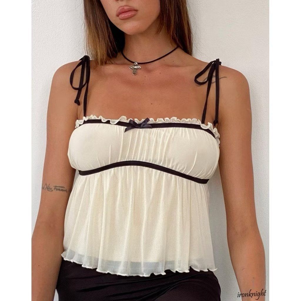 Cami Top In Cream With Black Centre Bow (Category: Blouses) located in San Fernando. Submitted by annecurates (Listing ID 1439118590, Image 2). Description: Mesh cream flowy top featuring black thin tie shoulder straps with frill neckline and centre bow detail..