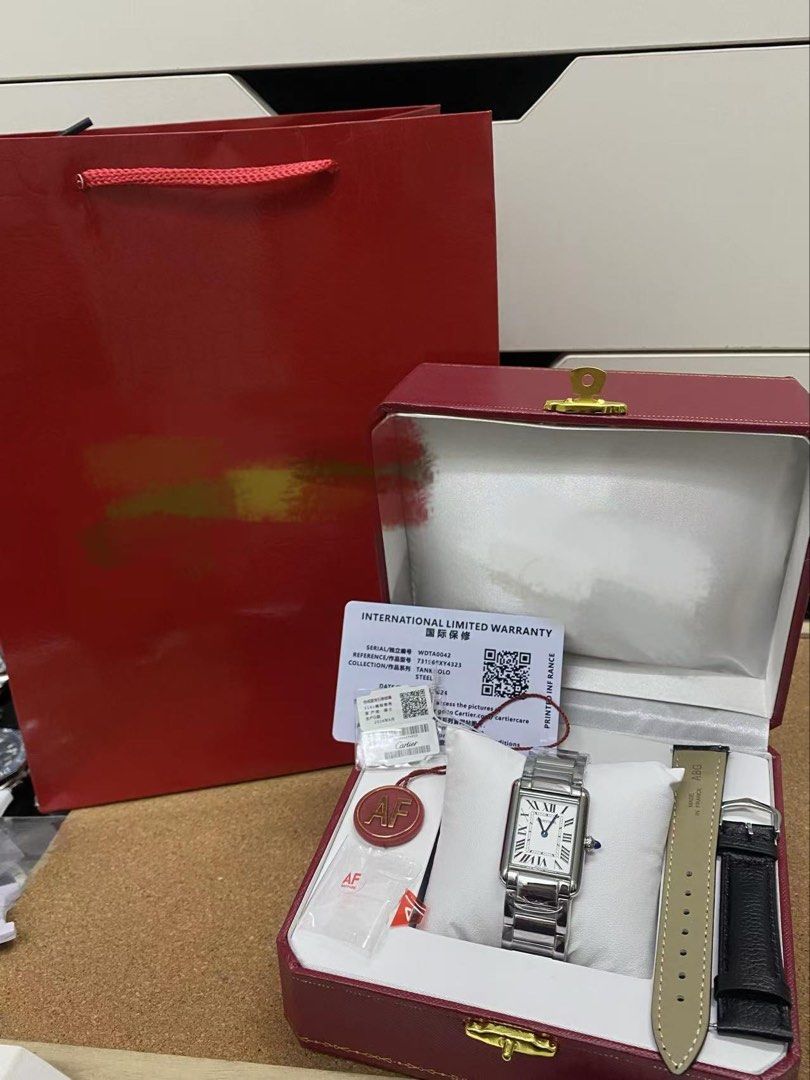 Cartier tank steel with extra strap (Category: Luxury Watches) located in San Juan City. Submitted by wristcheckdiaries (Listing ID 1439093556, Image 2). Description: - Big and small available - silver and gold available -easy to change strap - Authentic Cartier watch box - Deep red with gold trim - Includes: Cartier tag, Swiss International Guarantee card.