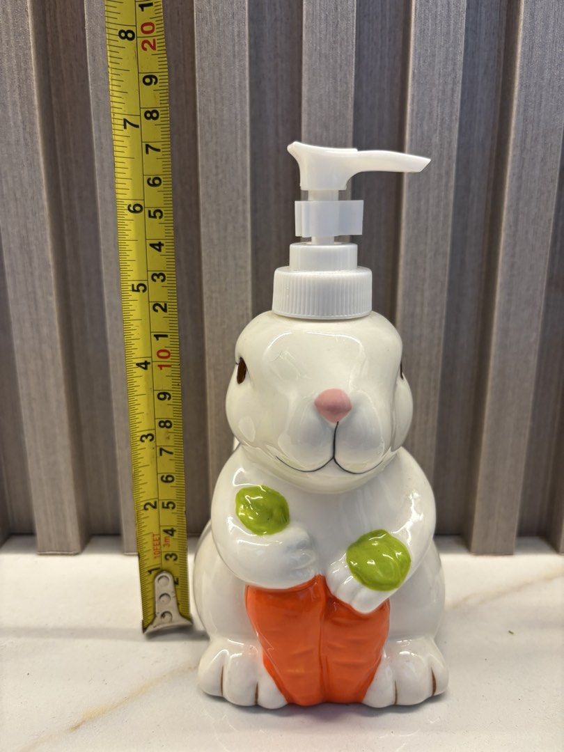 Ceramic Bunny Soap Dispenser (Category: Bath) located in Cavite. Submitted by ejp3773 (Listing ID 1439095457, Image 3). Description: - Adorable bunny-shaped soap dispenser. - Features a charming ceramic design. - Includes a white pump. - Detailed with pink ears and brown eyes. - Designed to hold liquid soap. - Perfect for bathroom or kitchen use. - never used. Displayed only..