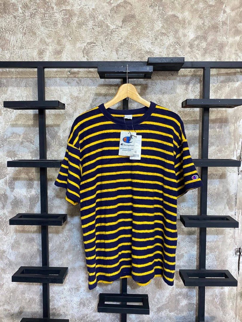 Champion Striped T-shirt (Category: Tshirts & Polo Shirts ) located in Sariaya. Submitted by hnw_19 (Listing ID 1439148938, Image 1). Description: - Champion striped t-shirt - Color: Navy blue and yellow - Features a crew neck and short sleeves - Relaxed fit - Champion logo on sleeve - Includes original tag.