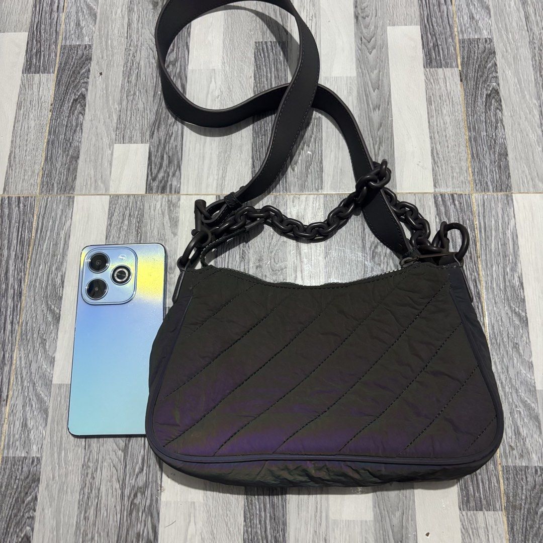 Charles & Keith Quilted Shoulder Bag (Category: Shoulder Bags) located in Banga. Submitted by akosiloco (Listing ID 1439079976, Image 3). Description: - Charles & Keith shoulder bag - Quilted design with iridescent finish - Chain strap and long strap included - Main compartment with interior pockets - Secure zipper closure - Authentic Charles & Keith label inside.