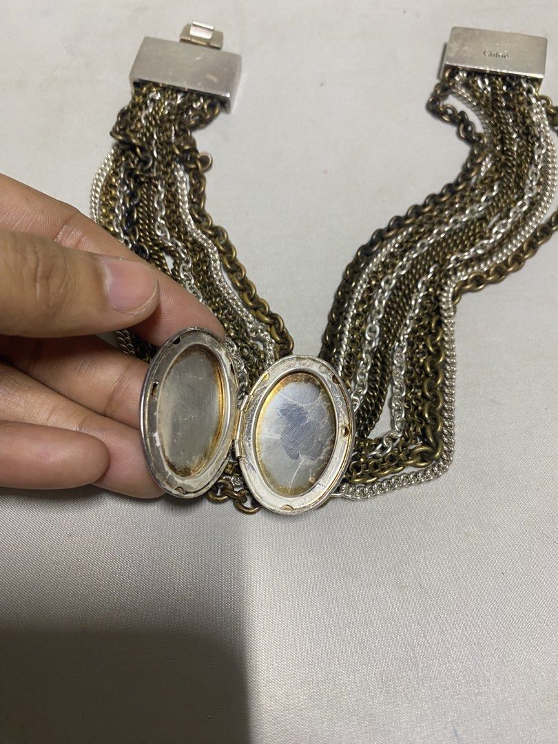 Chloe Chain Bracelet (Category: Bracelets) located in Pasacao. Submitted by wengpullar37205 (Listing ID 1439222055, Image 3). Description: - Chloe chain bracelet - Silver and gold tones - Features multiple chains - Oval-shaped decorative element - Magnetic clasp - Chloe logo on clasp - Statement piece -need po palinisan.