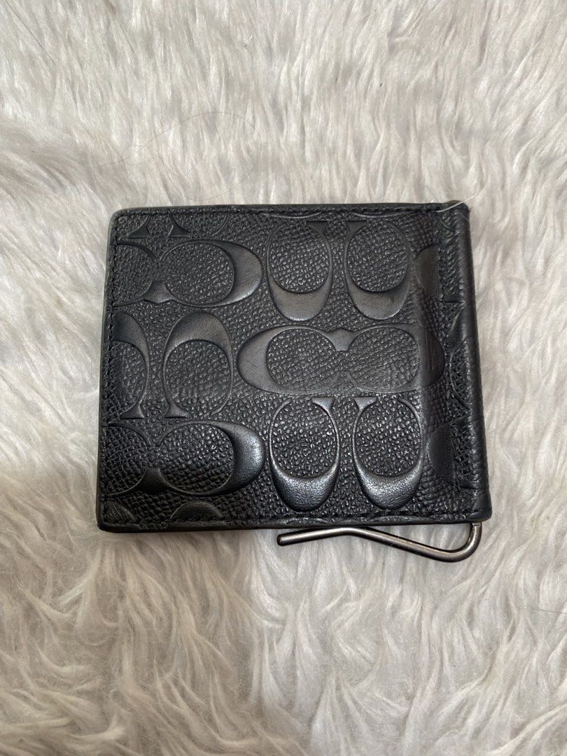 Coach Black Money Clip Wallet (Category: Luxury Bags & Wallets) located in Manila. Submitted by motscollections041421 (Listing ID 1439153471, Image 2). Description: - Black Coach money clip wallet - Debossed Coach logo exterior - Multiple card slots - Money clip included - Visible Coach logo inside - Made of leather.