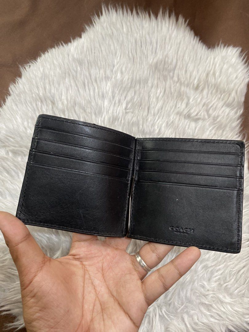 Coach Black Money Clip Wallet (Category: Luxury Bags & Wallets) located in Manila. Submitted by motscollections041421 (Listing ID 1439153471, Image 3). Description: - Black Coach money clip wallet - Debossed Coach logo exterior - Multiple card slots - Money clip included - Visible Coach logo inside - Made of leather.
