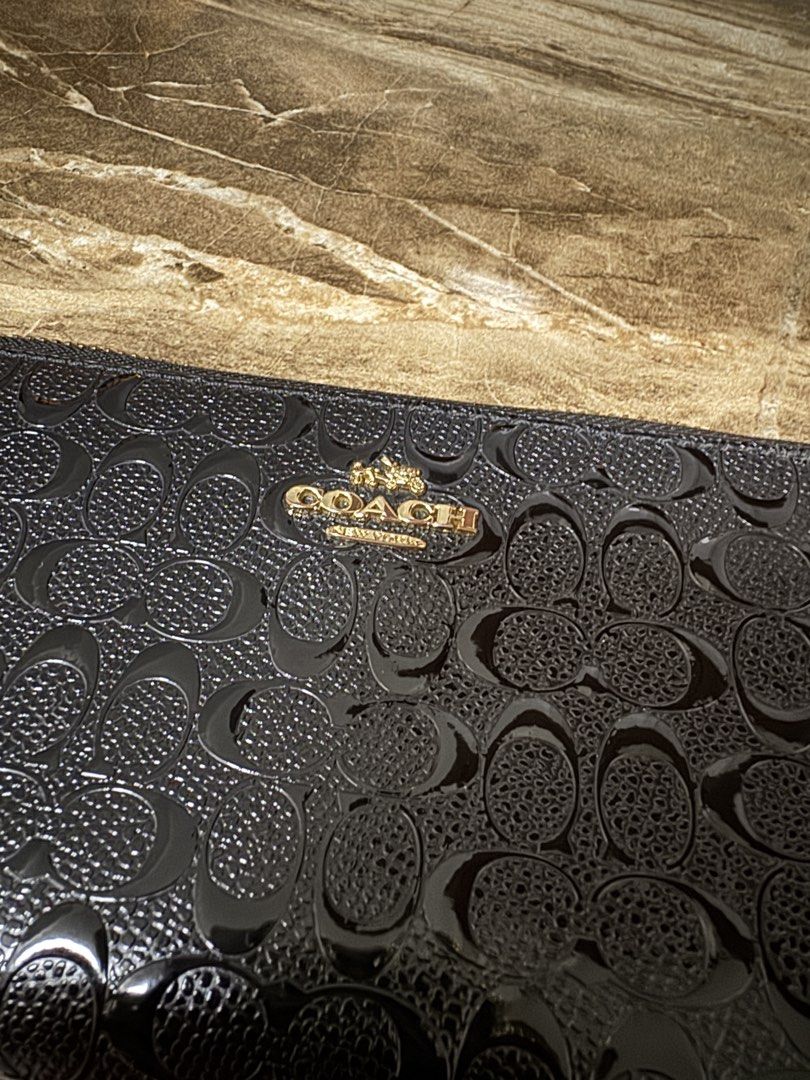 Coach Black Zip Around Wallet (Category: Luxury Bags & Wallets) located in Santa Rosa. Submitted by michiie143 (Listing ID 1439142258, Image 2). Description: - Black Coach zip-around wallet - Debossed Coach logo - Multiple card slots - Bill compartments - Gold-toned zipper and hardware - Coach logo visible on front Nagbabakbak un leather s ilalim pero okay pa sya.