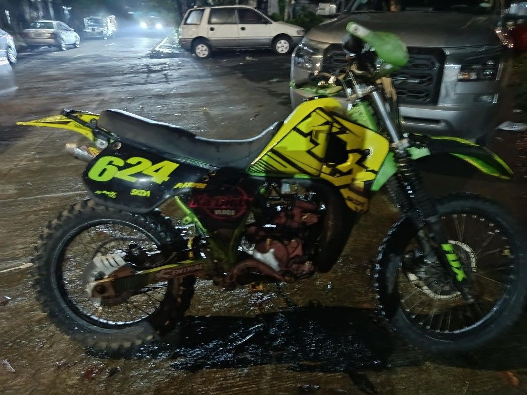 Dirt Bike Motorcycle (Category: Motorbikes for Sale) located in Caloocan City. Submitted by florespatrickjohntbk (Listing ID 1439085029, Image 2). Description: Dirt bike features a striking yellow and green color scheme. It has the number "624" displayed prominently. The bike has off-road tires and a Dunlop rear fender. It is suitable for off-road adventures..