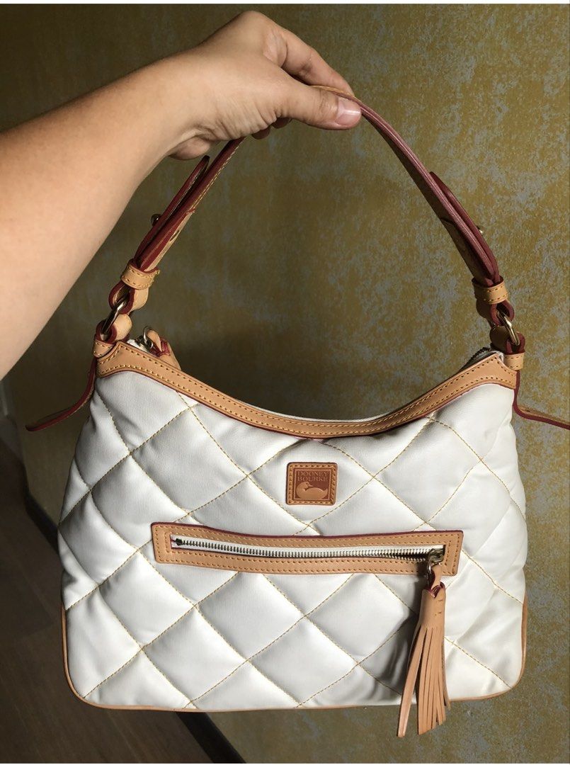 Dooney & Bourke White Quilted Shoulder Bag (Category: Luxury Bags & Wallets) located in Quezon City. Submitted by cprmob (Listing ID 1439120667, Image 1). Description: - Authentic Dooney & Bourke shoulder bag - Elegant quilted white exterior with tan trim - Secure zippered main compartment - Convenient front zippered pocket - Versatile carrying options: top handle and shoulder strap - Stylish tassel detail.
