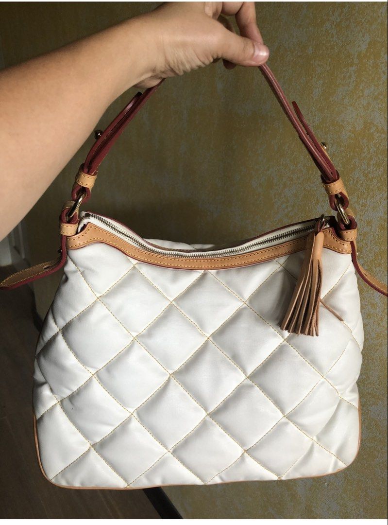 Dooney & Bourke White Quilted Shoulder Bag (Category: Luxury Bags & Wallets) located in Quezon City. Submitted by cprmob (Listing ID 1439120667, Image 2). Description: - Authentic Dooney & Bourke shoulder bag - Elegant quilted white exterior with tan trim - Secure zippered main compartment - Convenient front zippered pocket - Versatile carrying options: top handle and shoulder strap - Stylish tassel detail.