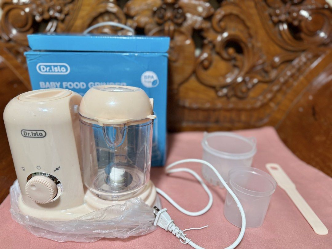 Dr. Isla Baby Food Grinder (Category: Weaning & Toddler Feeding) located in Quezon City. Submitted by obsessedwithbagsbymsjpq (Listing ID 1439104519, Image 1). Description: - Dr. Isla baby food grinder Used 2-3x only. Shifted to baby led weaning immediately - Includes: main unit, 2 small containers, spatula, and box - Features adjustable grinding settings - Color: Beige.