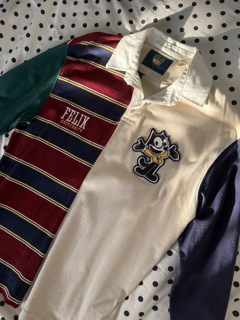 Felix Levi's Rugby Shirt (Category: Tshirts & Polo Shirts ) located in Quezon City. Submitted by kyudotcom (Listing ID 1439159958, Image 1). Description: Rugby shirt features a unique color block design with a Felix the Cat patch. It has a collared neckline and long sleeves. The shirt has the Felix Levi's logo on the collar and sleeve. Made in Pakistan. Size S..