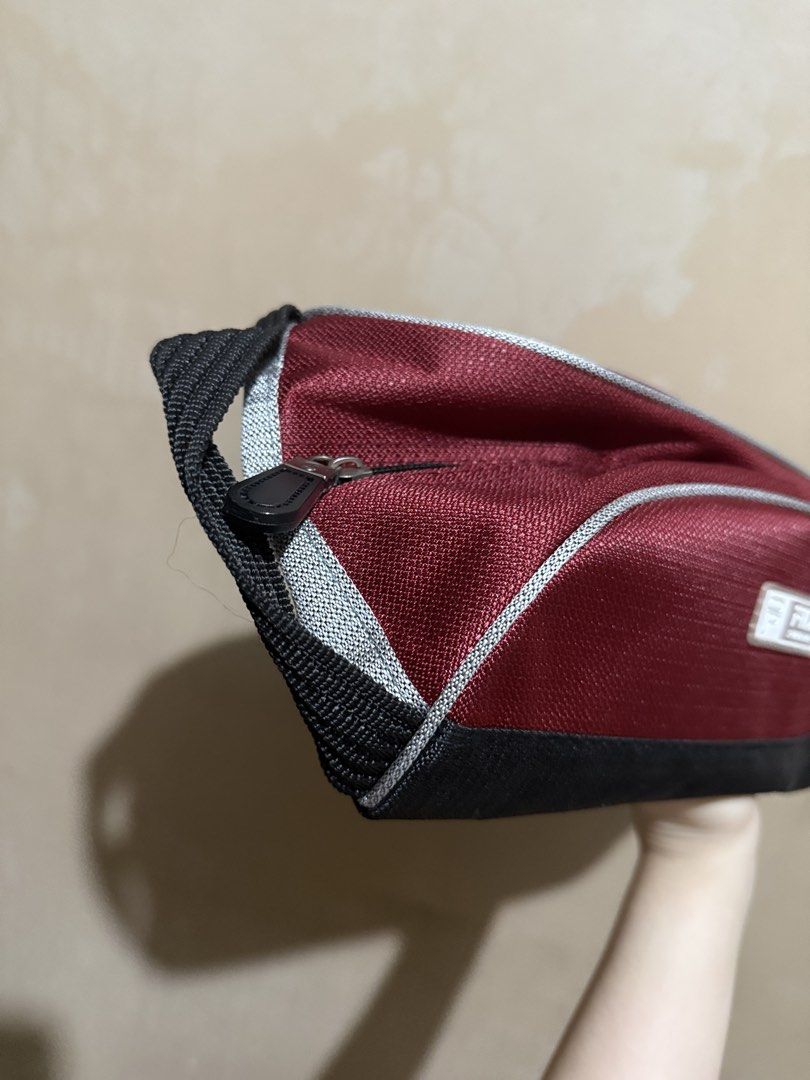 Fila Sportlife Maroon Bag (Category: Shoulder Bags) located in Malabon City. Submitted by thylanapparel (Listing ID 1439124440, Image 3). Description: - Maroon Fila bag with a black base and handle. - Silver trim and zipper closure. - Black interior. - Rectangular shape. - Fila logo on the front. - Top handle for easy carrying..
