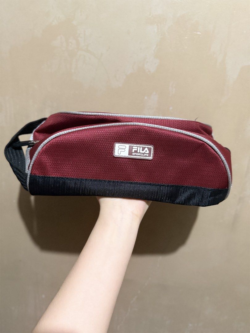 Fila Sportlife Maroon Bag (Category: Shoulder Bags) located in Malabon City. Submitted by thylanapparel (Listing ID 1439124440, Image 1). Description: - Maroon Fila bag with a black base and handle. - Silver trim and zipper closure. - Black interior. - Rectangular shape. - Fila logo on the front. - Top handle for easy carrying..