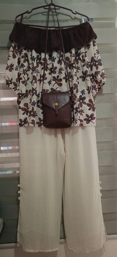 Floral Off-Shoulder Top with Pants and Bag (Category: Sets or Coordinates) located in Rodriguez. Submitted by maycol (Listing ID 1439076721, Image 3). Description: - Floral off-shoulder top with brown and blue accents - Cream-colored pants with button details - Small brown crossbody bag - Ideal for casual wear.