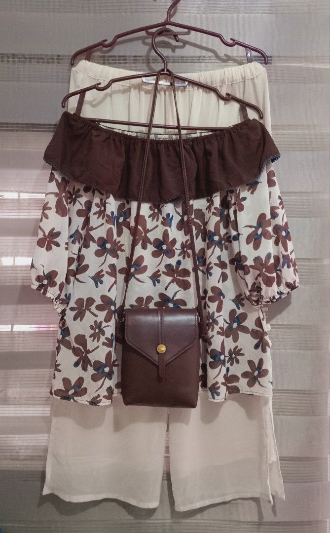 Floral Off-Shoulder Top with Pants and Bag (Category: Sets or Coordinates) located in Rodriguez. Submitted by maycol (Listing ID 1439076721, Image 1). Description: - Floral off-shoulder top with brown and blue accents - Cream-colored pants with button details - Small brown crossbody bag - Ideal for casual wear.