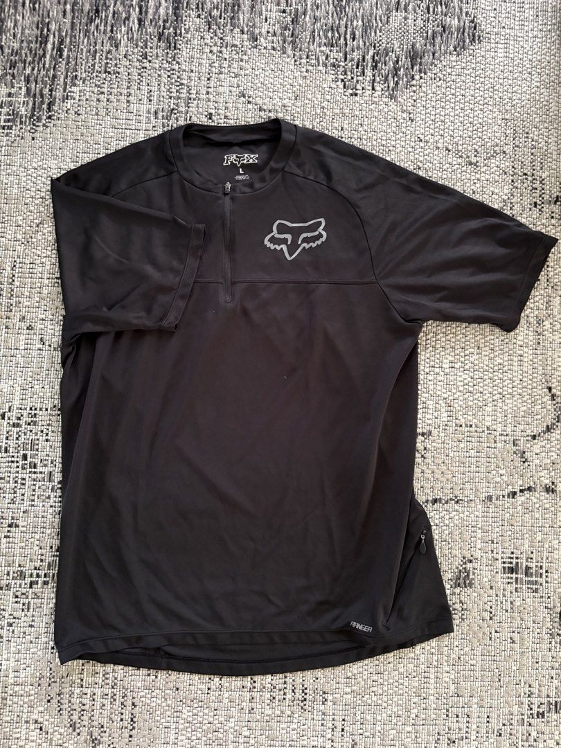 Fox Ranger Jersey - Black - Large (Category: Activewear) located in Binan City. Submitted by morticias_vault (Listing ID 1439118020, Image 2). Description: - Black Fox Ranger jersey - Size: Large - Half-zip closure - Fox logo on the chest - Small zippered pocket on the side Zipper pull was torn but overall shirt is good. .