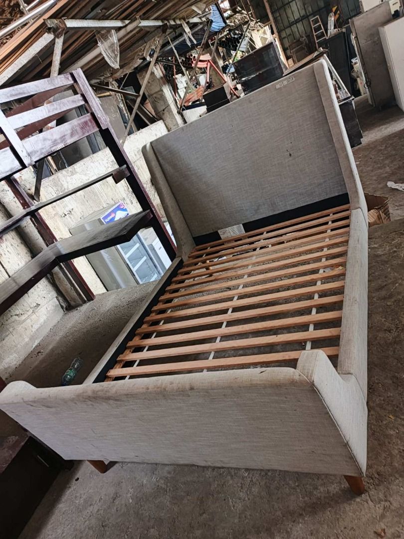 FULL SIZE DOUBLE Bed Frame WITH MATTRESS (Category: Bed Frames & Mattresses) located in San Pedro. Submitted by cgi.saversplustrading (Listing ID 1439082543, Image 2). Description: - Upholstered bed frame - Light-colored fabric - Headboard with side wings - Wooden slats included - Wooden legs.