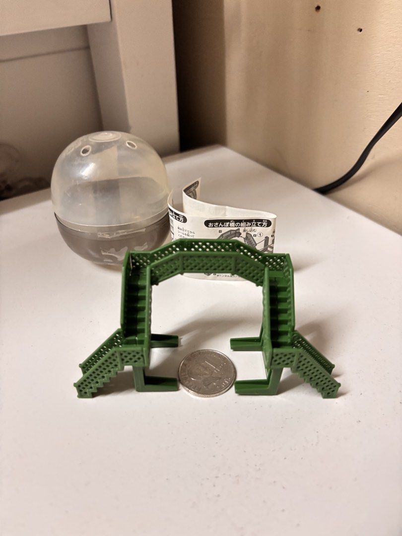 Gashapon Miniature Green Bridge (Category: Designer & Blind Box Toys) located in Pasay City. Submitted by tindeclutterstuff (Listing ID 1439149703, Image 1). Description: - Miniature green bridge - Ideal for model train sets or dioramas - Features detailed stairways and textured surface - Comes with original capsule and instructions - Coin included for size reference - Collectible item #gashapon #diorama #dioramatoys #dioramaminis .