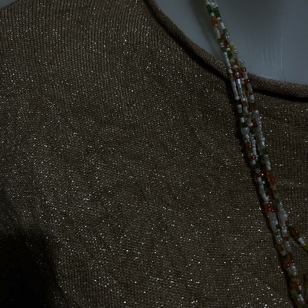 Gold Shimmer Knit Top (Category: Blouses) located in Paranaque City. Submitted by kyriaki_thrift_shop (Listing ID 1439161663, Image 2). Description: - Gold shimmer knit top - Round neckline - Short sleeves - Textured fabric - Dress up or down - Suitable for various occasions.