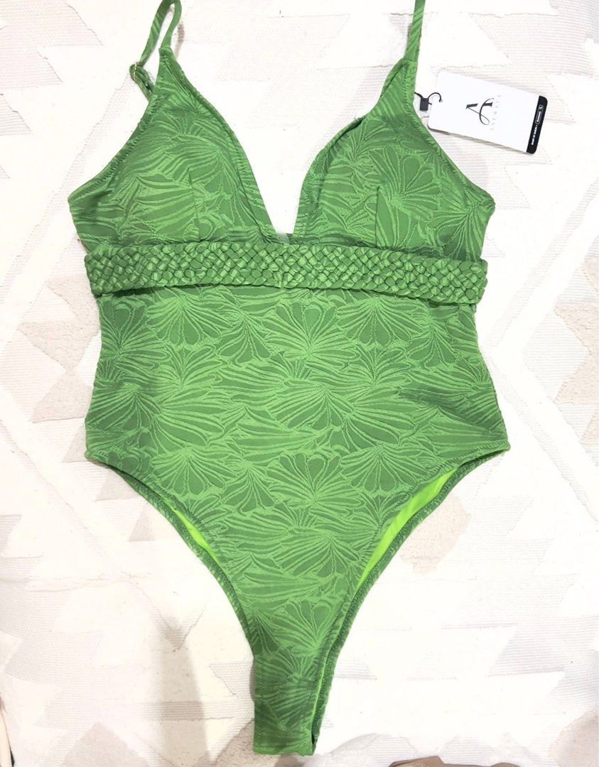 Green One-Piece textured Swimsuit (Category: Bikinis & Swimsuits) located in Taguig. Submitted by Love2Shop (Listing ID 1439121233, Image 1). Description: - Brand new one-piece swimsuit - Vibrant green color - Unique textured pattern - Flattering V-neckline - Adjustable straps for a perfect fit - Stylish braided waist detail - Comes with original tags.