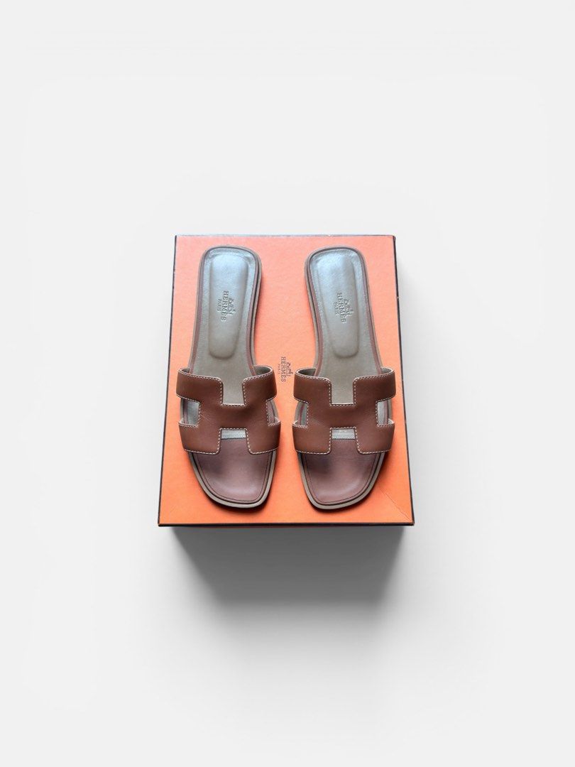 Hermes Oran Sandals (Category: Sneakers & Footwear) located in Makati City. Submitted by size9pls (Listing ID 1439205044, Image 1). Description: - Authentic Hermes Oran sandals - Color: Gold - Iconic "H" cut-out design - Gently used condition - Comes with original box - Perfect for everyday wear - Classic and stylish Size 38 1/2.