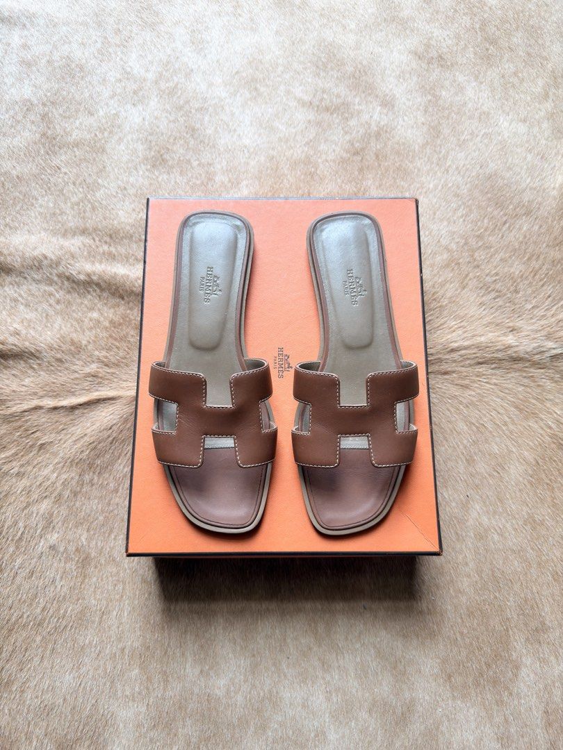 Hermes Oran Sandals (Category: Sneakers & Footwear) located in Makati City. Submitted by size9pls (Listing ID 1439205044, Image 2). Description: - Authentic Hermes Oran sandals - Color: Gold - Iconic "H" cut-out design - Gently used condition - Comes with original box - Perfect for everyday wear - Classic and stylish Size 38 1/2.