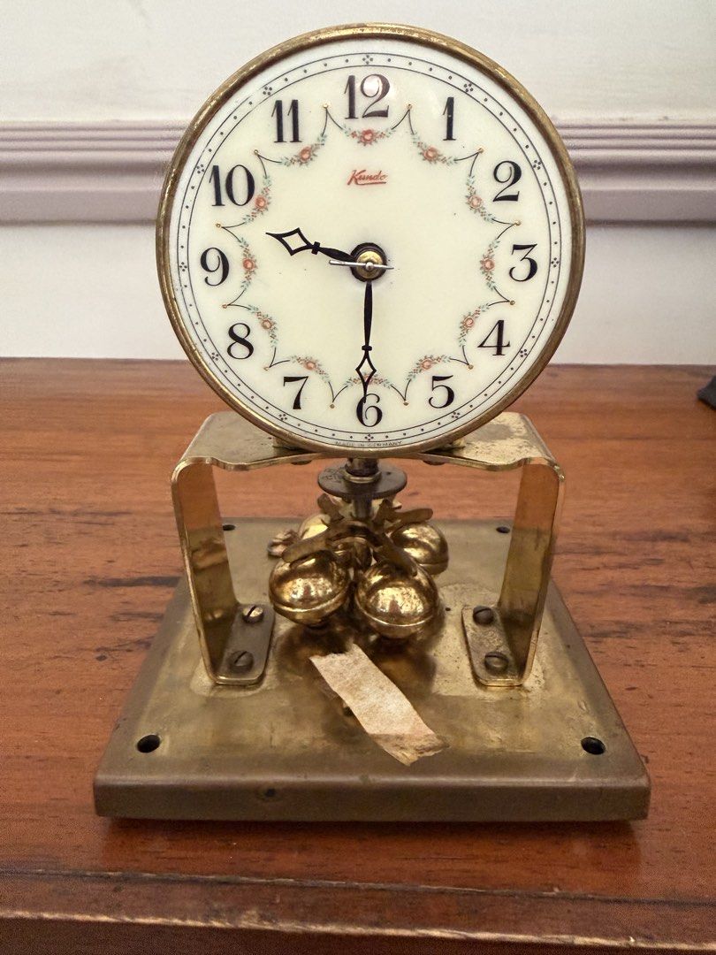 Kamado Vintage Clock (Category: Clocks) located in Las Pinas. Submitted by mightybird.a4339c (Listing ID 1439112456, Image 2). Description: - Vintage Kamado clock - Cream-colored face with floral accents - Brass frame - Features small bells - Classic design with Roman numerals - Perfect for home decor.