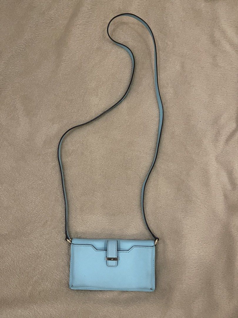 Kate Spade Blue Crossbody Wallet Bag (Category: Cross-body Bags) located in Mandaluyong City. Submitted by jgpreluvs (Listing ID 1439110170, Image 3). Description: SALE!! - Kate Spade crossbody bag - Light blue exterior and strap - Snap closure - Interior card slots - Clear ID window - Shoulder or crossbody wear 📌 Fits small phone and other knick-knacks 🤍 Straps can be removed if you want to use as a wallet only ❗️Small unnoticeable stains (can