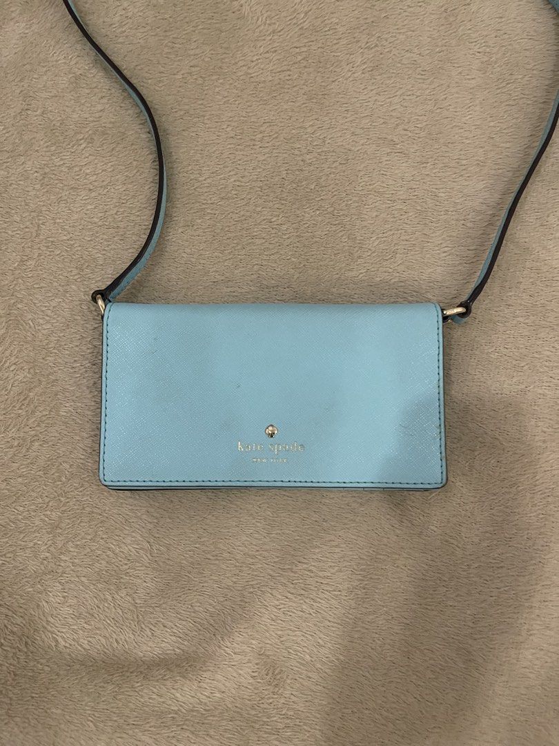 Kate Spade Blue Crossbody Wallet Bag (Category: Cross-body Bags) located in Mandaluyong City. Submitted by jgpreluvs (Listing ID 1439110170, Image 2). Description: SALE!! - Kate Spade crossbody bag - Light blue exterior and strap - Snap closure - Interior card slots - Clear ID window - Shoulder or crossbody wear 📌 Fits small phone and other knick-knacks 🤍 Straps can be removed if you want to use as a wallet only ❗️Small unnoticeable stains (can