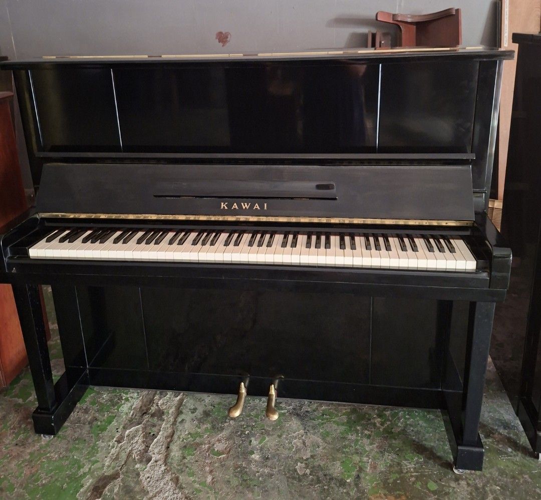 Kawai Upright Piano (Category: Musical Instruments) located in Angono. Submitted by vapianoshop (Listing ID 1439161370, Image 3). Description: - Black Kawai upright piano - Full keyboard with white and black keys - Two pedals - Glossy black finish - Kawai logo visible.