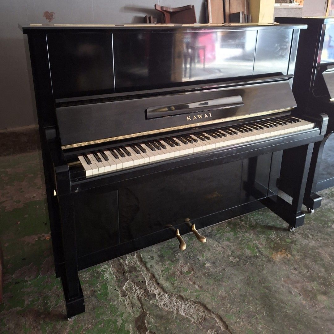 Kawai Upright Piano (Category: Musical Instruments) located in Angono. Submitted by vapianoshop (Listing ID 1439161370, Image 1). Description: - Black Kawai upright piano - Full keyboard with white and black keys - Two pedals - Glossy black finish - Kawai logo visible.