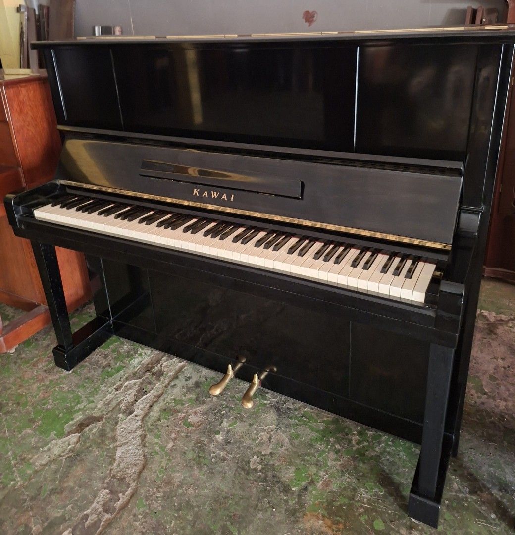 Kawai Upright Piano (Category: Musical Instruments) located in Angono. Submitted by vapianoshop (Listing ID 1439161370, Image 2). Description: - Black Kawai upright piano - Full keyboard with white and black keys - Two pedals - Glossy black finish - Kawai logo visible.