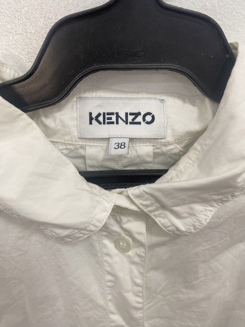 Kenzo White Shirt Size 38 (Category: Shirts) located in General Trias. Submitted by mangu_ukay (Listing ID 1439164107, Image 3). Description: - Kenzo white shirt - Size 38 - Collared neckline - Button-down closure - Two front pockets - Long sleeves - Relaxed fit - Made in Tunisia - Includes washing instructions tag.