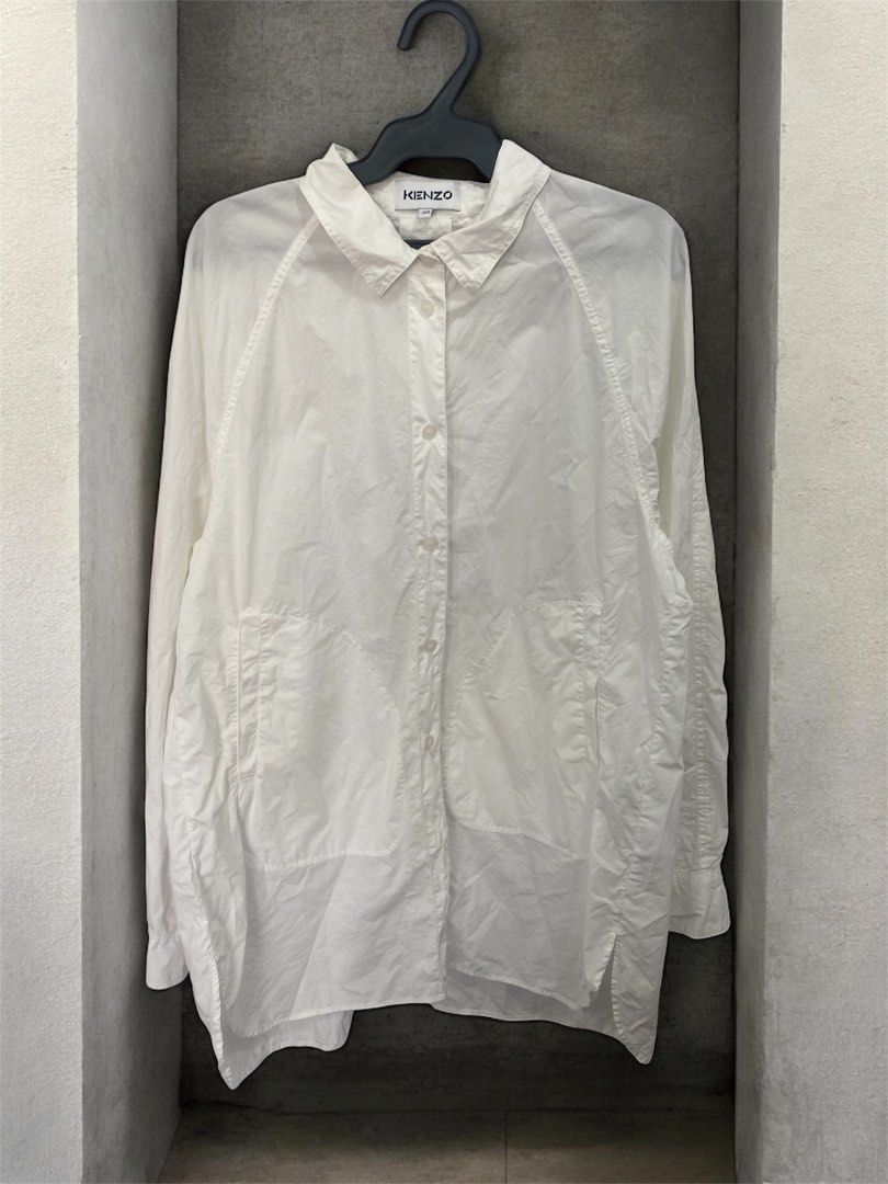 Kenzo White Shirt Size 38 (Category: Shirts) located in General Trias. Submitted by mangu_ukay (Listing ID 1439164107, Image 1). Description: - Kenzo white shirt - Size 38 - Collared neckline - Button-down closure - Two front pockets - Long sleeves - Relaxed fit - Made in Tunisia - Includes washing instructions tag.