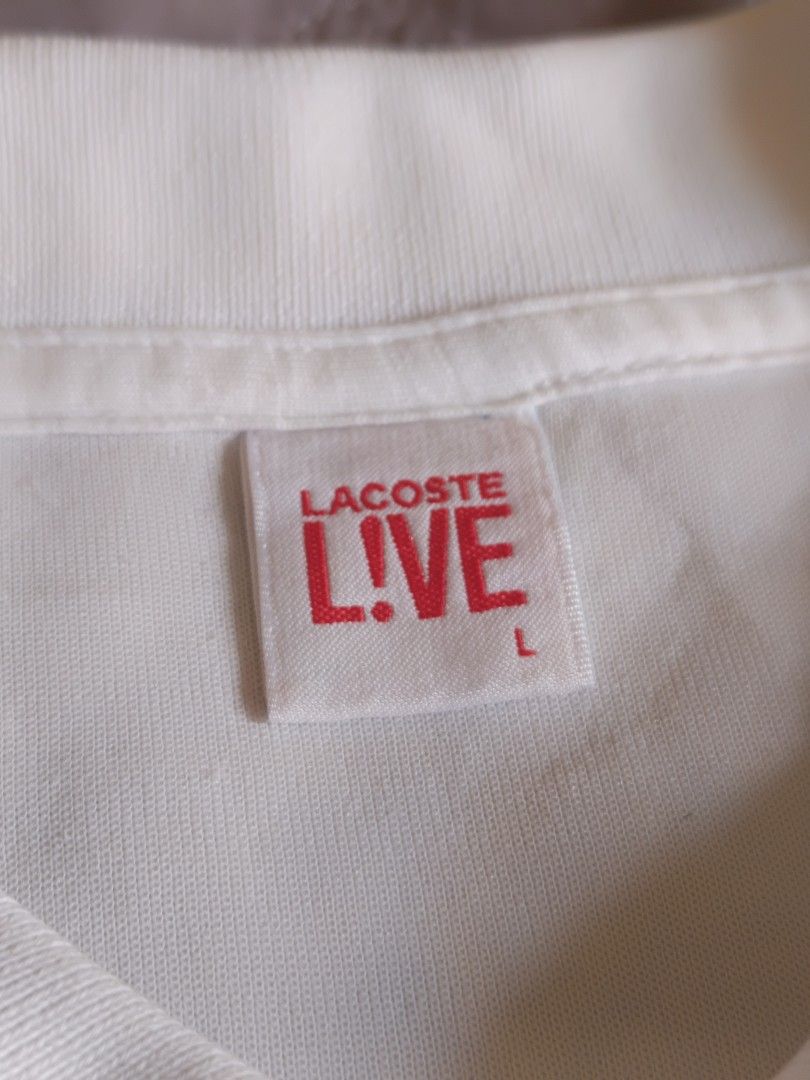 Lacoste L!VE White Polo Shirt (Category: Tshirts & Polo Shirts ) located in Cabuyao City. Submitted by bentleyboy_fire (Listing ID 1439223106, Image 1). Description: 1k+sf Excellent Condition White Lacoste L!VE polo shirt - Features the iconic crocodile logo - Pleated waist design - Size: L on tag - Dimes: L: 25 W:20 - Made in China - Fabric: 60% cotton, 40% polyester - Style number: DF4875 - Authentic - PSG OUT - Issue: minimal lints (barelynoti